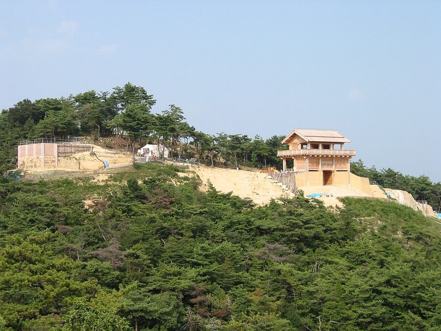 The reconstructed west gate of Kinojo Castle on a ridgeline above Soja