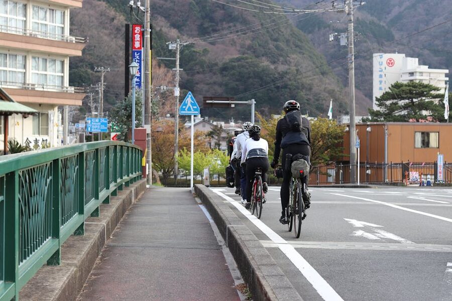 Cyclists on a rural Japanese road in autumn