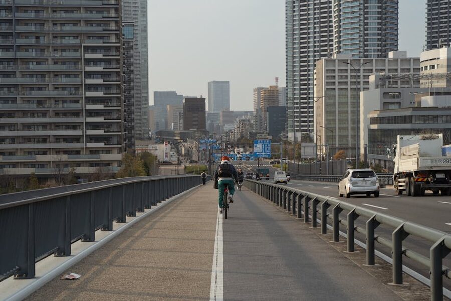 Cyclist on a Tokyo highway with skyscrapers