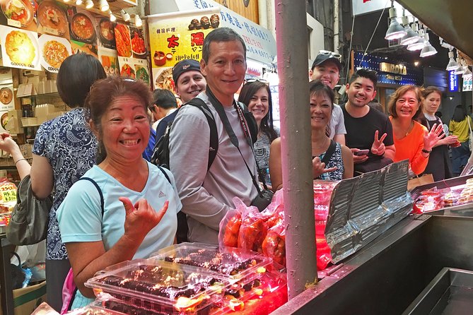 Eat, Drink & Cycle: Osaka Foodie Bike Tour - Meeting beneath Tsutenkaku and setting up the bikes